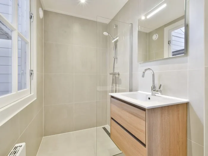 Ducha a ras de suelo con sumidero lineal, mampara fija de vidrio y mueble de lavabo de madera, cambiar plato de ducha precio Zaragoza